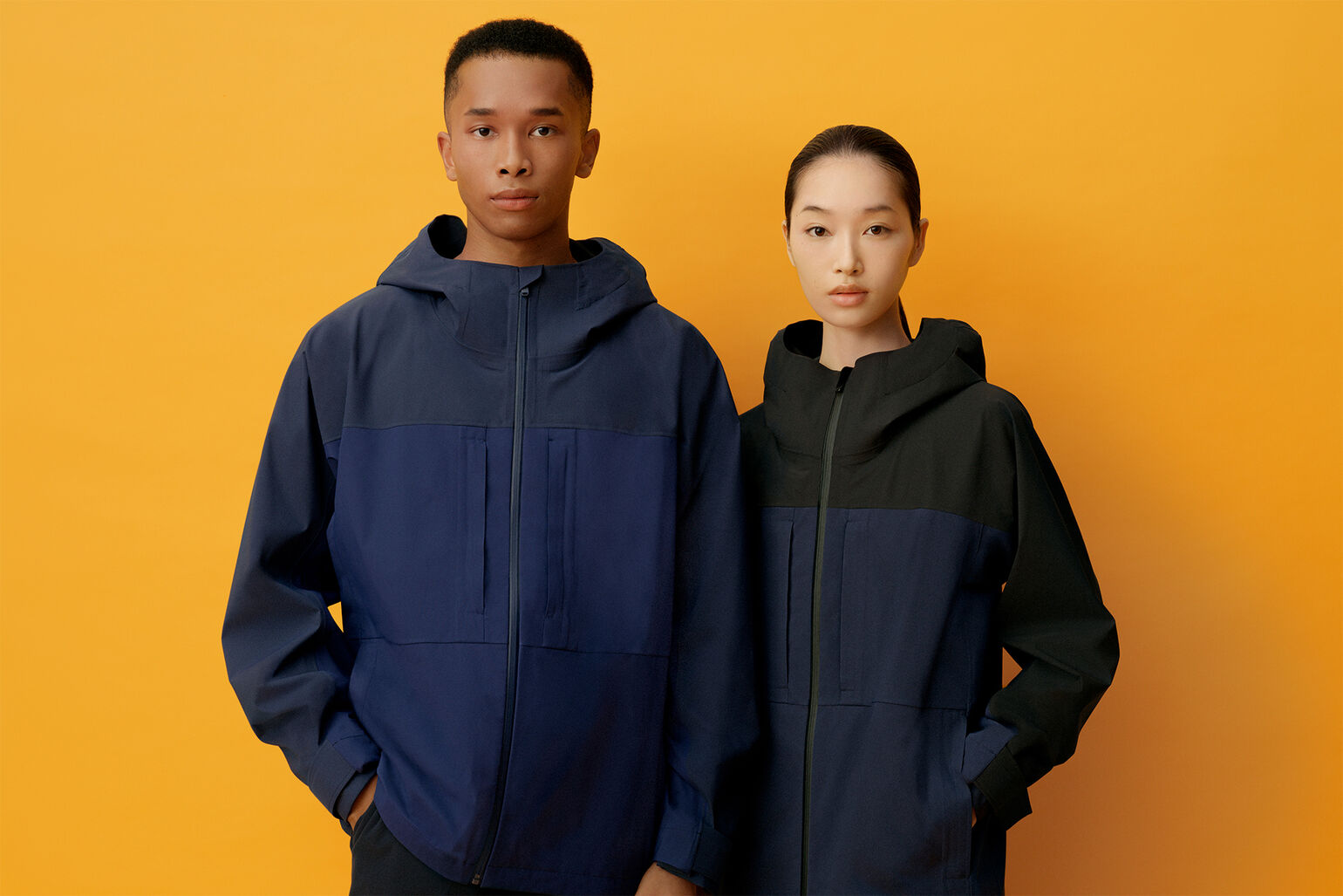 Image of a man and woman wearing a BLOCKTECH Parka