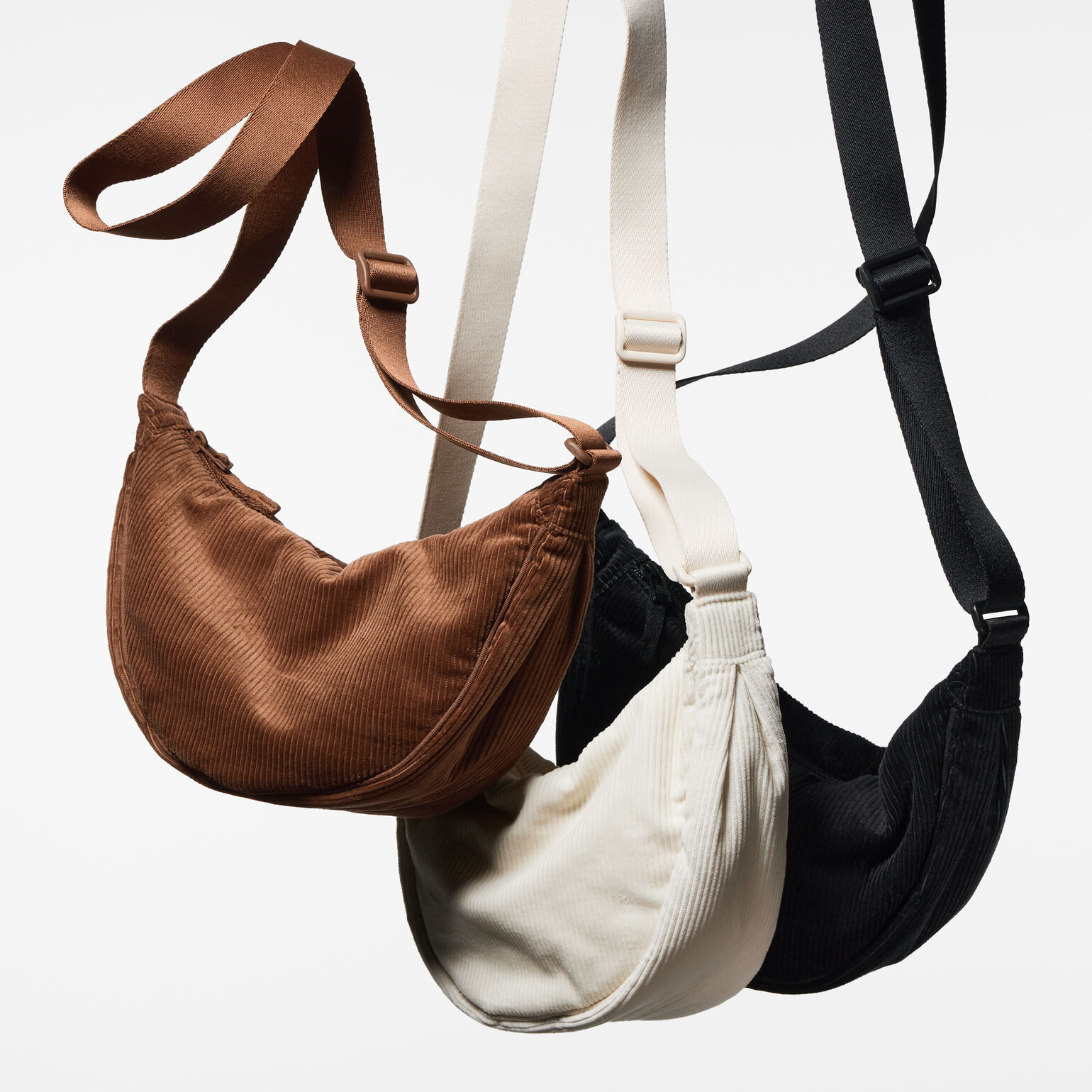 UNIQLO runde Cord Mini Schultertasche in braun, weiß und schwarz