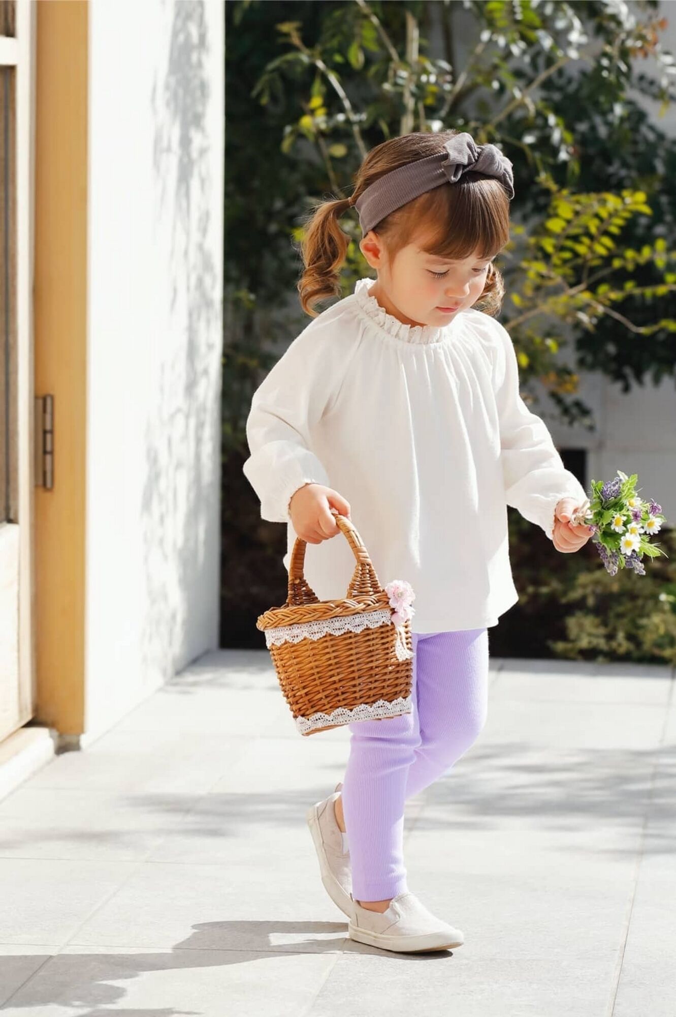 baby girl wearing a long sleeved white t-shirt