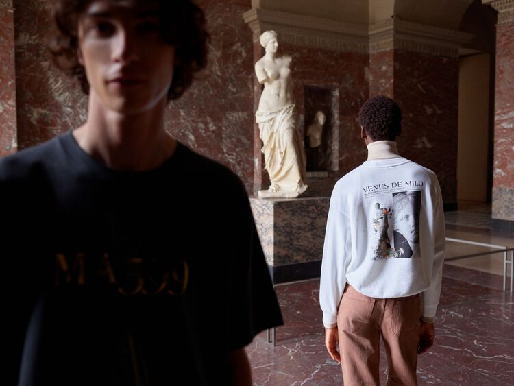 Models wearing a uniqlo ut t-shirt and uniqlo ut sweatshirt