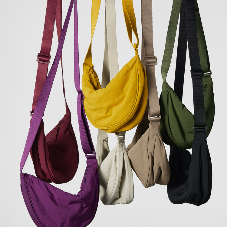 several UNIQLO Round Mini Shoulder Bags hanging