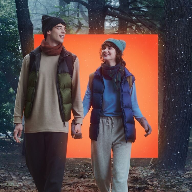 Man and women wearing UNIQLO HEATTECH accessories