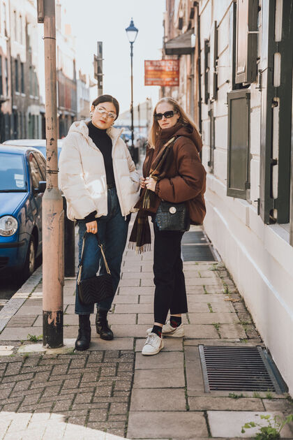 Girls on the street wearing down coats