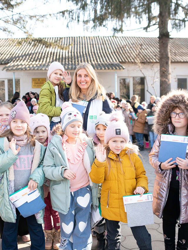 children holding HEATTECH thermal clothing donations