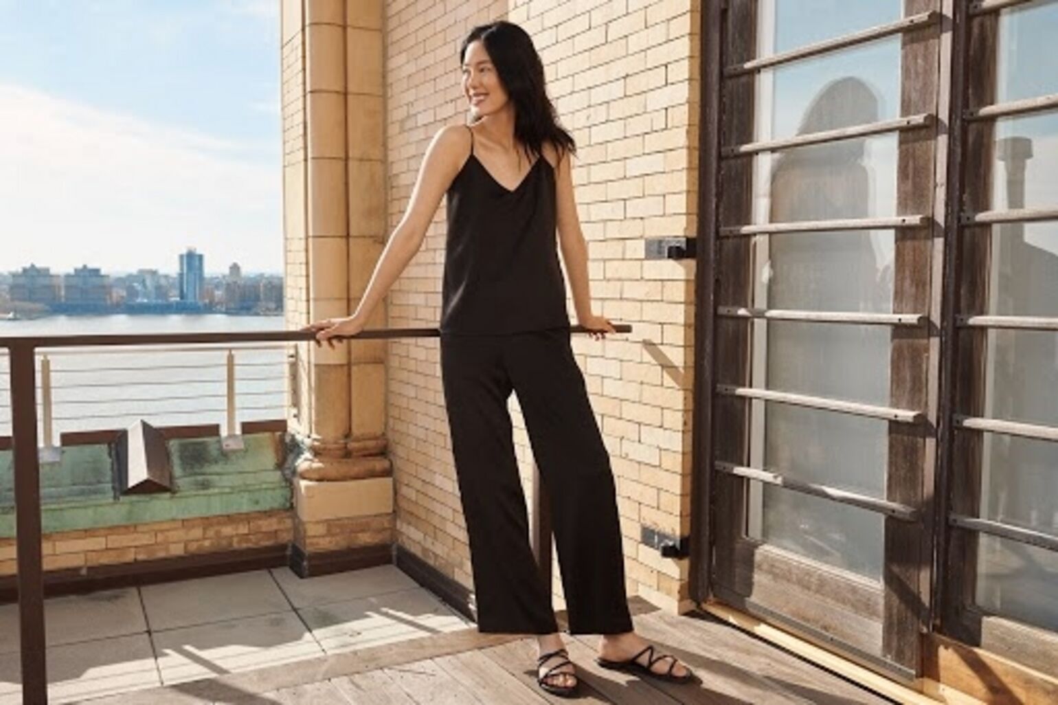 woman wearing UNIQLO black camisole and black trousers
