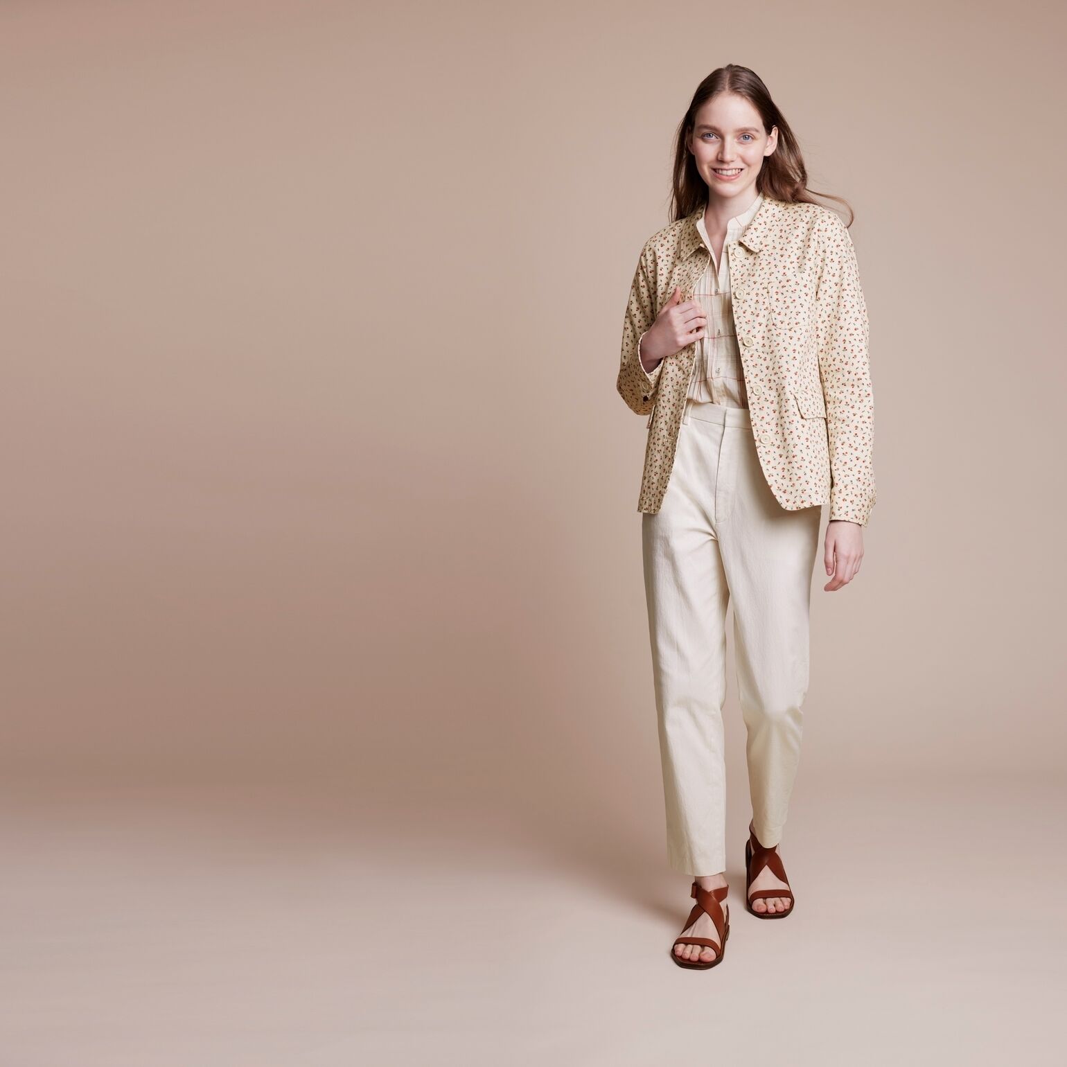 model wearing Ines de la Fressange cotton coverall, shirt, and trousers
