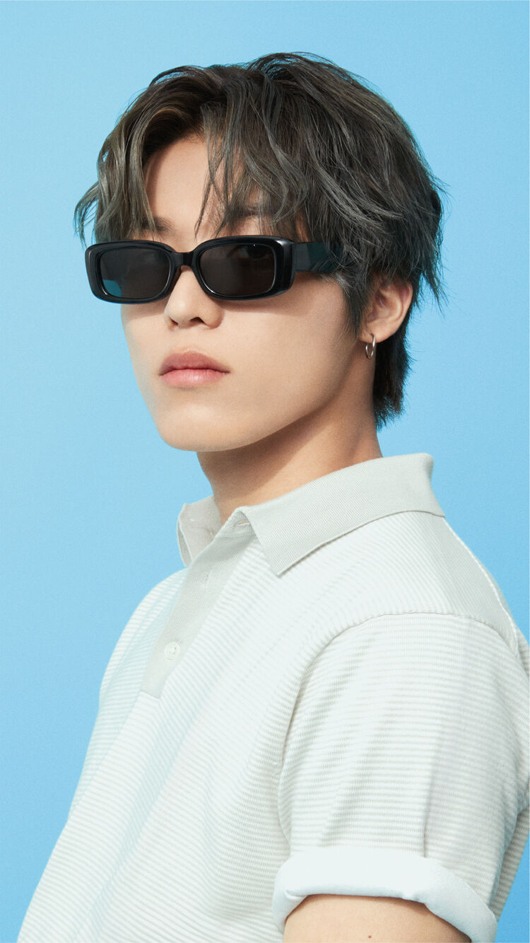A close-up image of PARK JEONG WOO exuding an intellectual vibe, wearing NARROW TYPE Rectangle Sunglasses that accent his polo shirt collar.