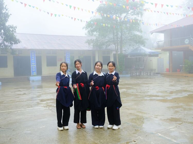 A group of female students makes the heart sign in the playground of their boarding school in Vietnam. Cristina de Middel Magnum Photos