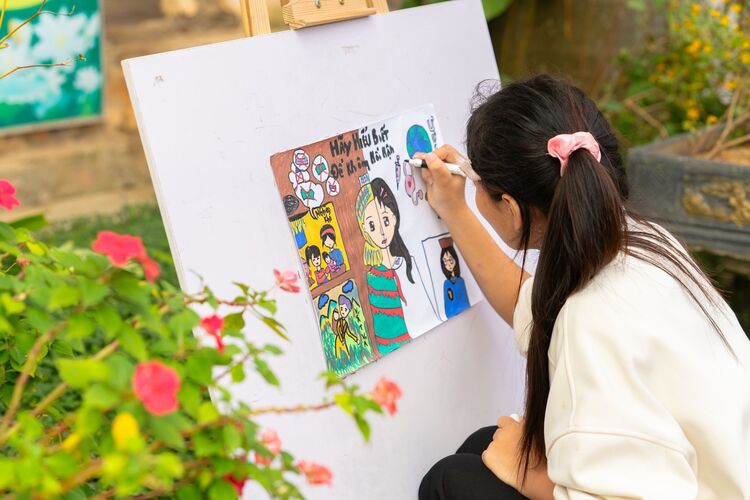 A child painting outdoors