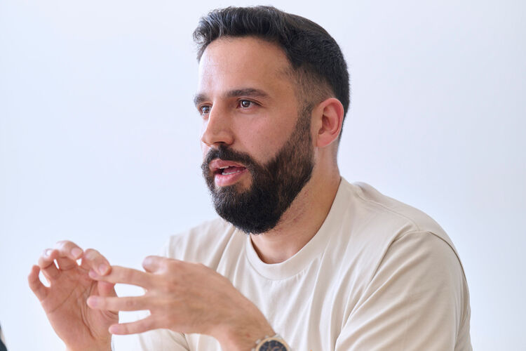 Close-up photo of Husam Kattan being interviewed.