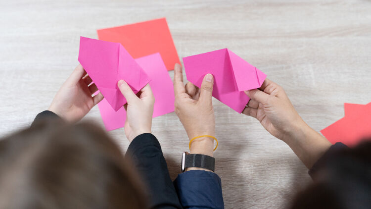Image of someone folding a message card