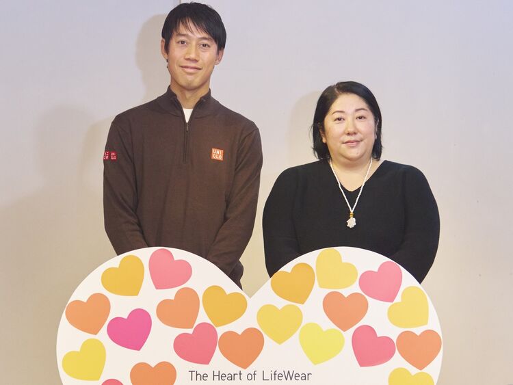 An image of Kei Nishikori and a woman smiling side by side behind a heart-shaped message board.