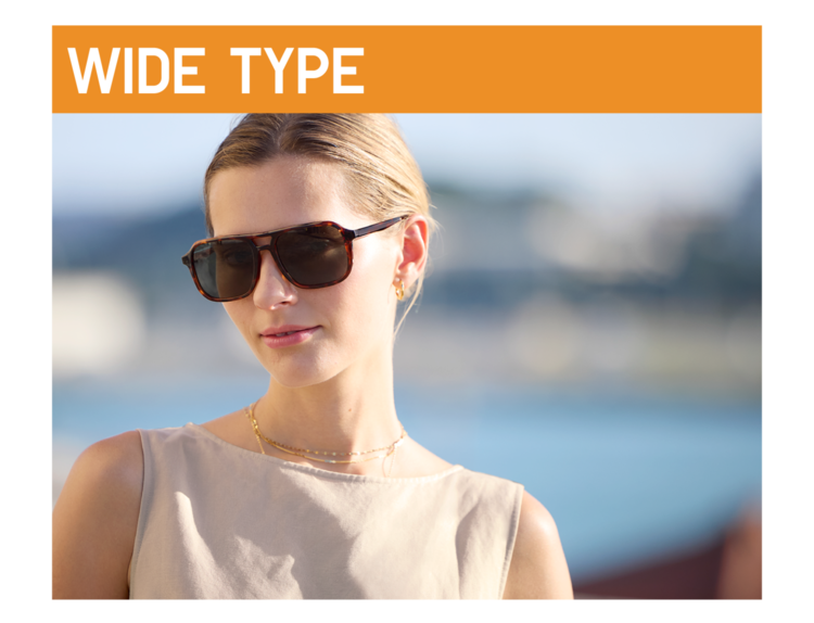 A close-up image of a woman with a gentle expression in the sunlight, wearing large square-shaped sunglasses under an orange 