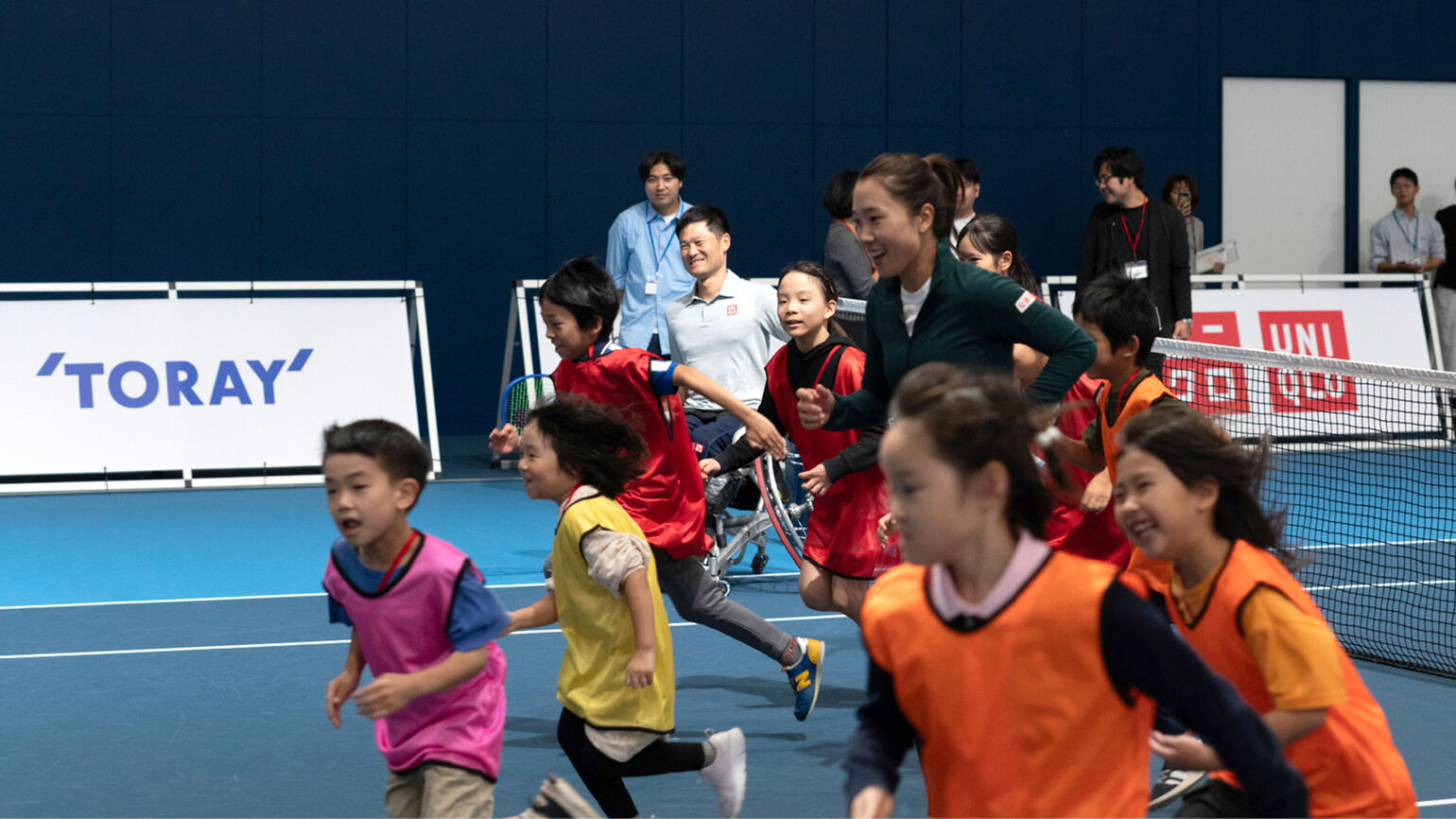 An image of children running together for a warm-up.