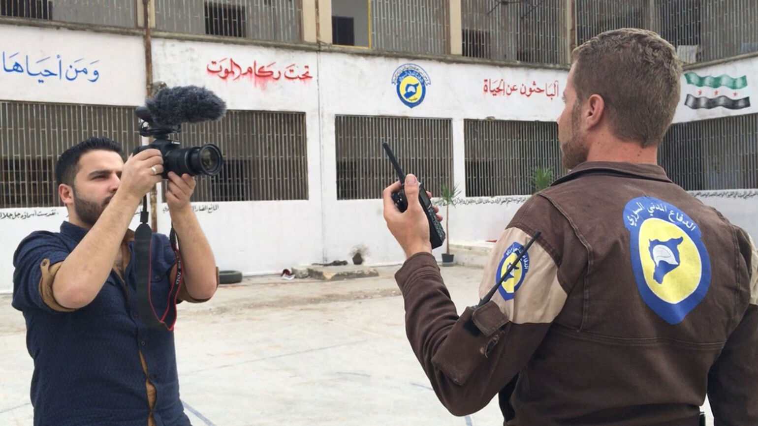 Image of Husam Kattan photographing a man tracking a helicopter.