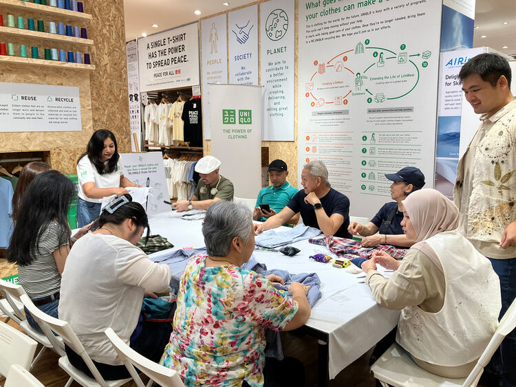 Image of people sewing/doing needlework together at a table