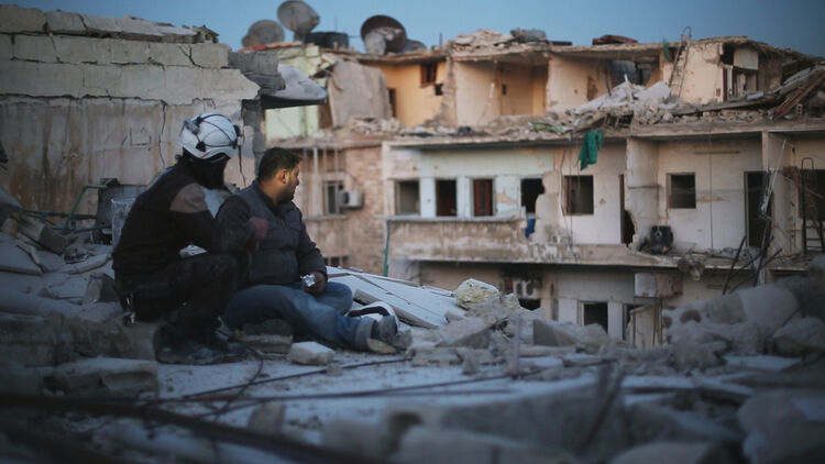 Image of a person sitting and looking out at the city.