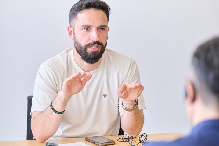 Front-facing image of Husam Kattan being interviewed.
