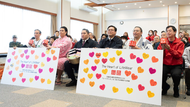 Group photo of sumo wrestlers and local citizens