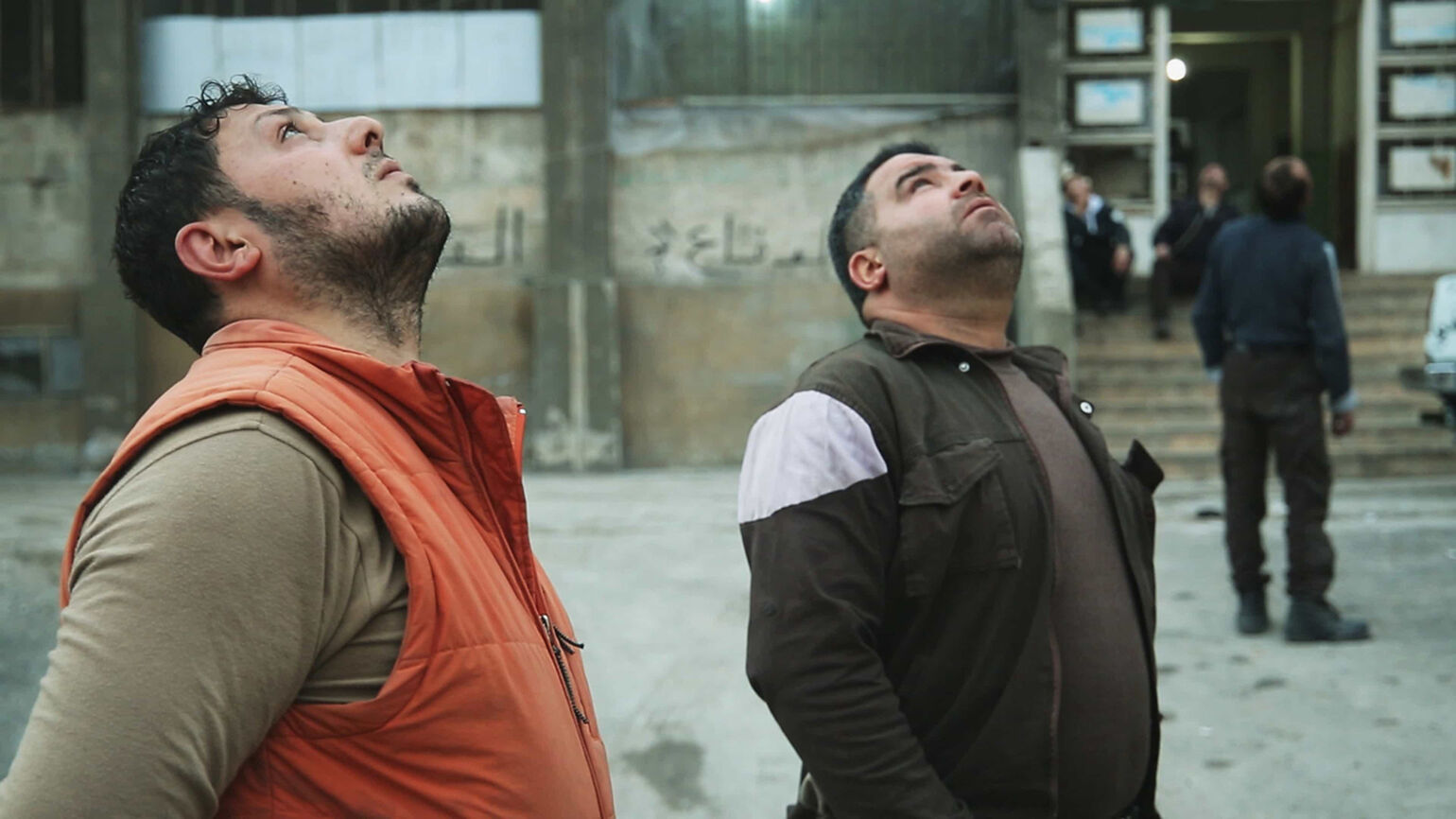 Image of people looking up at the sky.