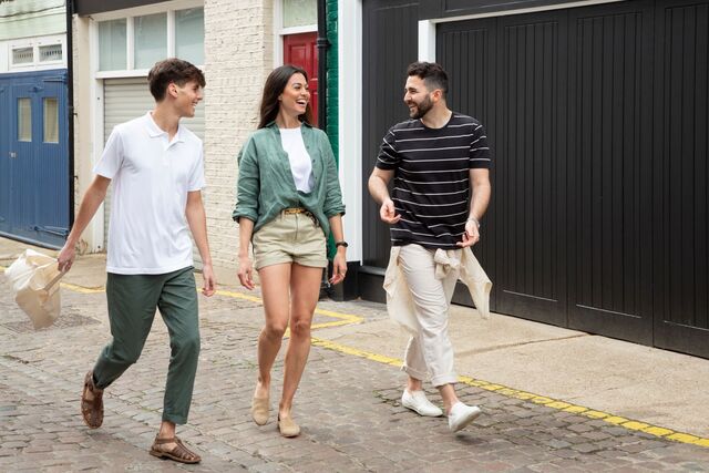 two men and a woman wearing sustainable clothing