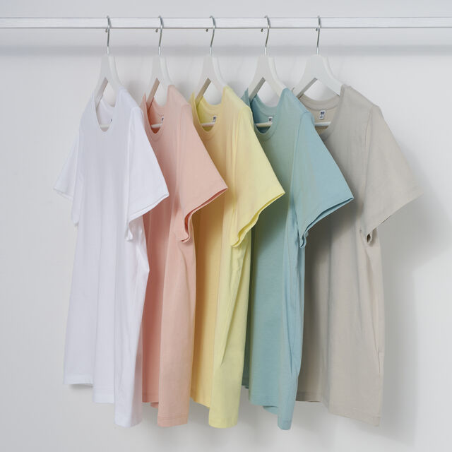five hanging T-shirts in different pastel colours
