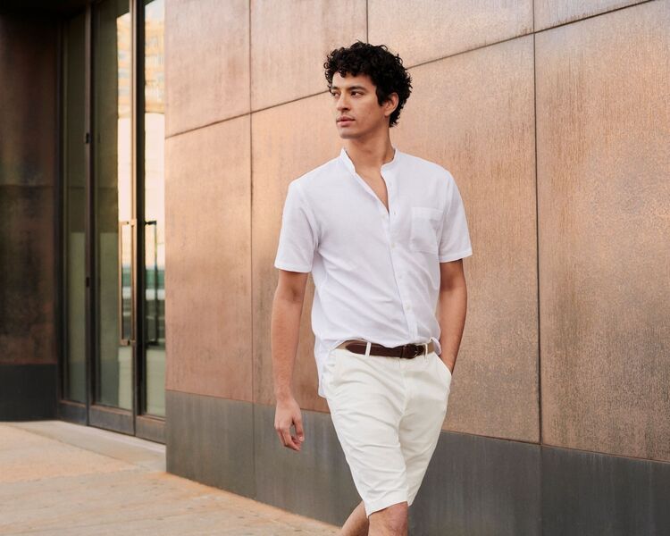 Man wearing a short sleeved linen shirt and chino shorts