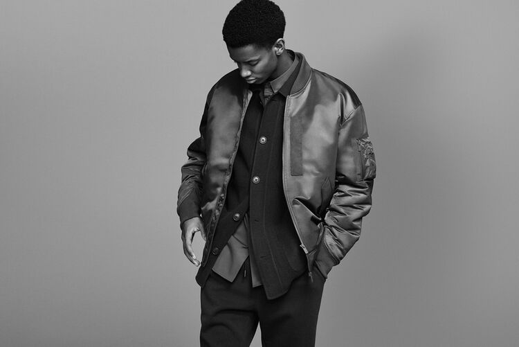 Man wearing a +J down oversized ma-1 blouson