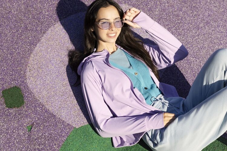 Female model wearing UV protection clothes in violet, blue and grey