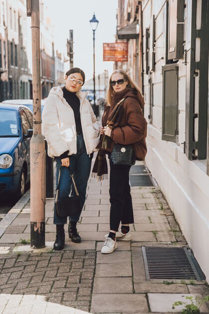 Girls on the street wearing down coats