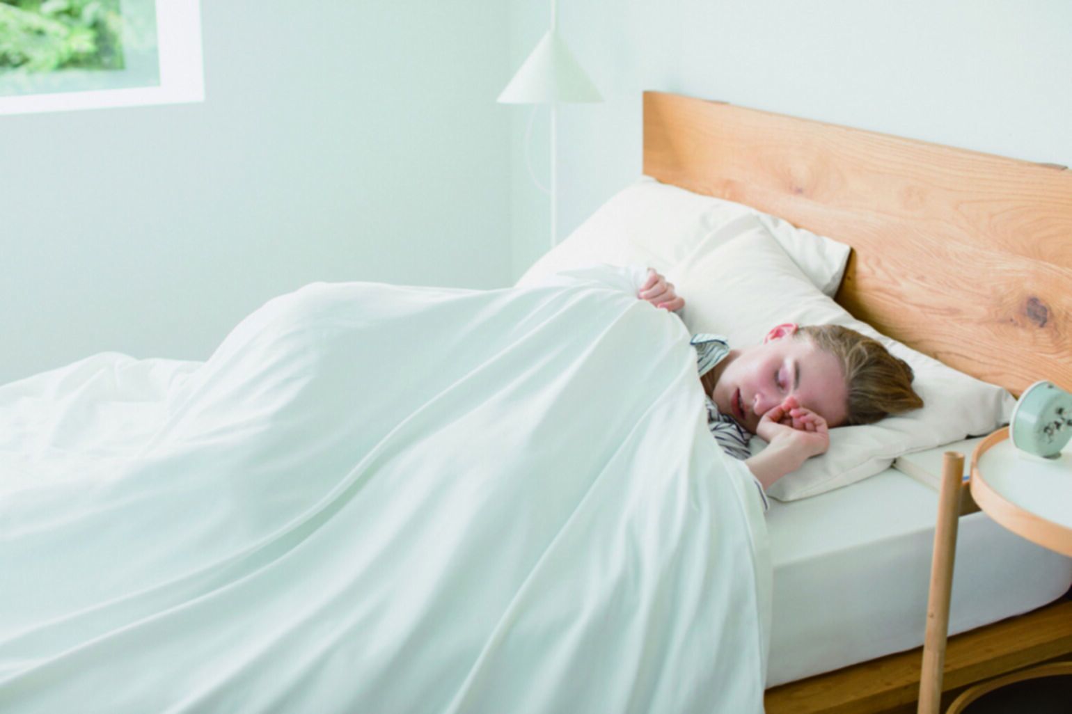 girl sleeping in white UNIQLO bedding