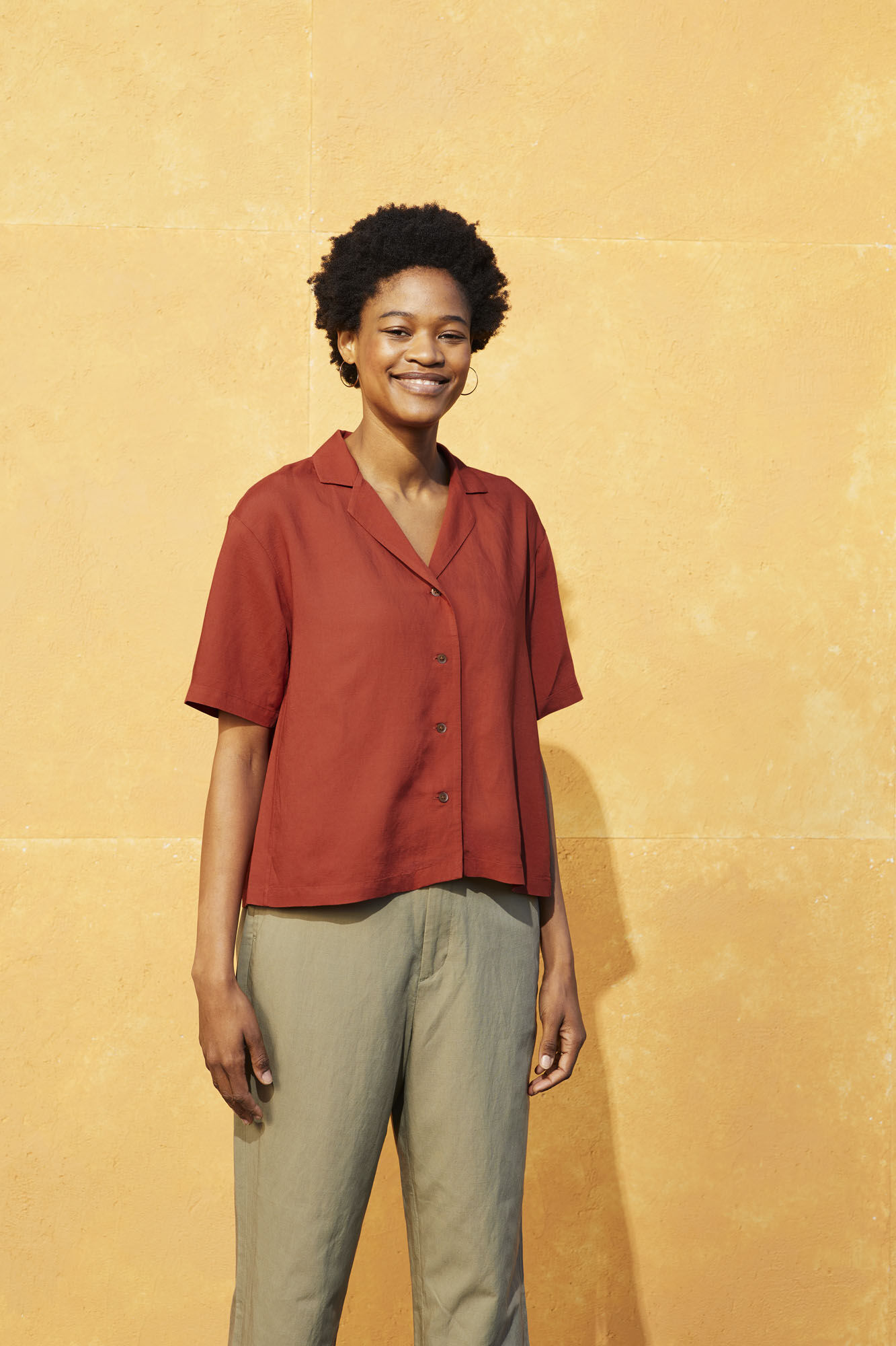 Woman wearing a short sleeved linen shirt and a linen trouser
