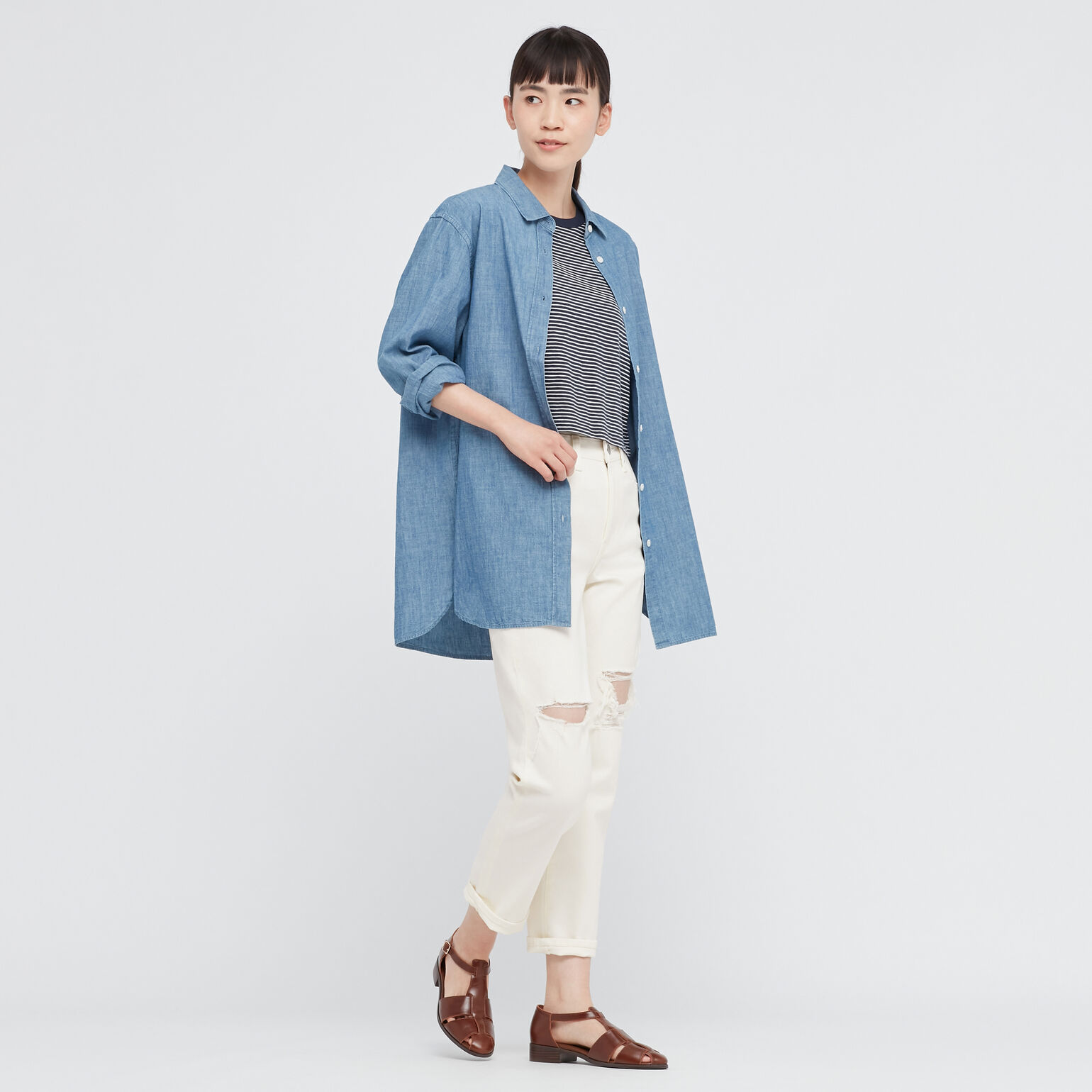 woman wearing UNIQLO ripped jeans, jersey striped cropped T-shirt and oversized chambray shirt
