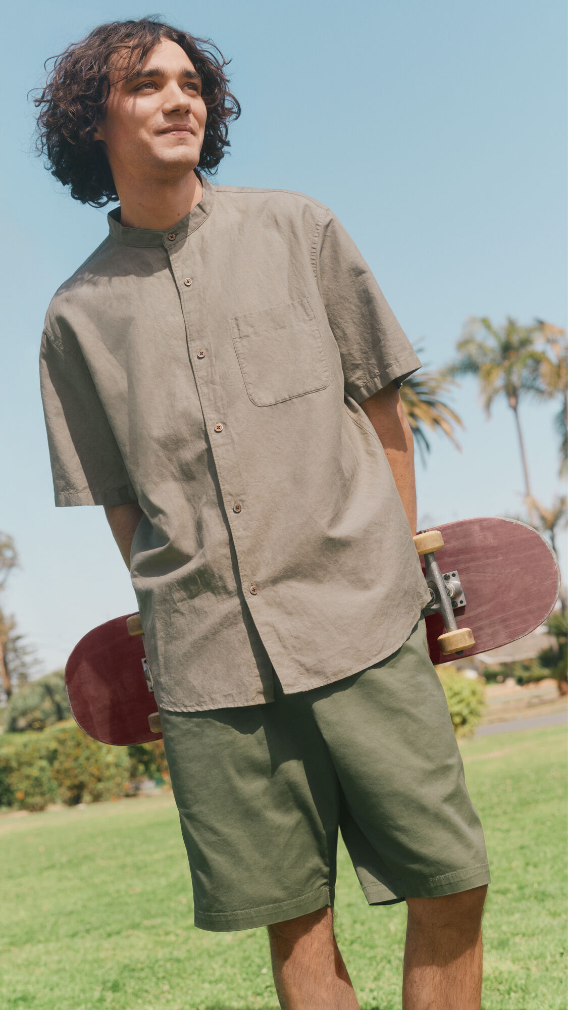 model wearing short sleeved shirt and shorts