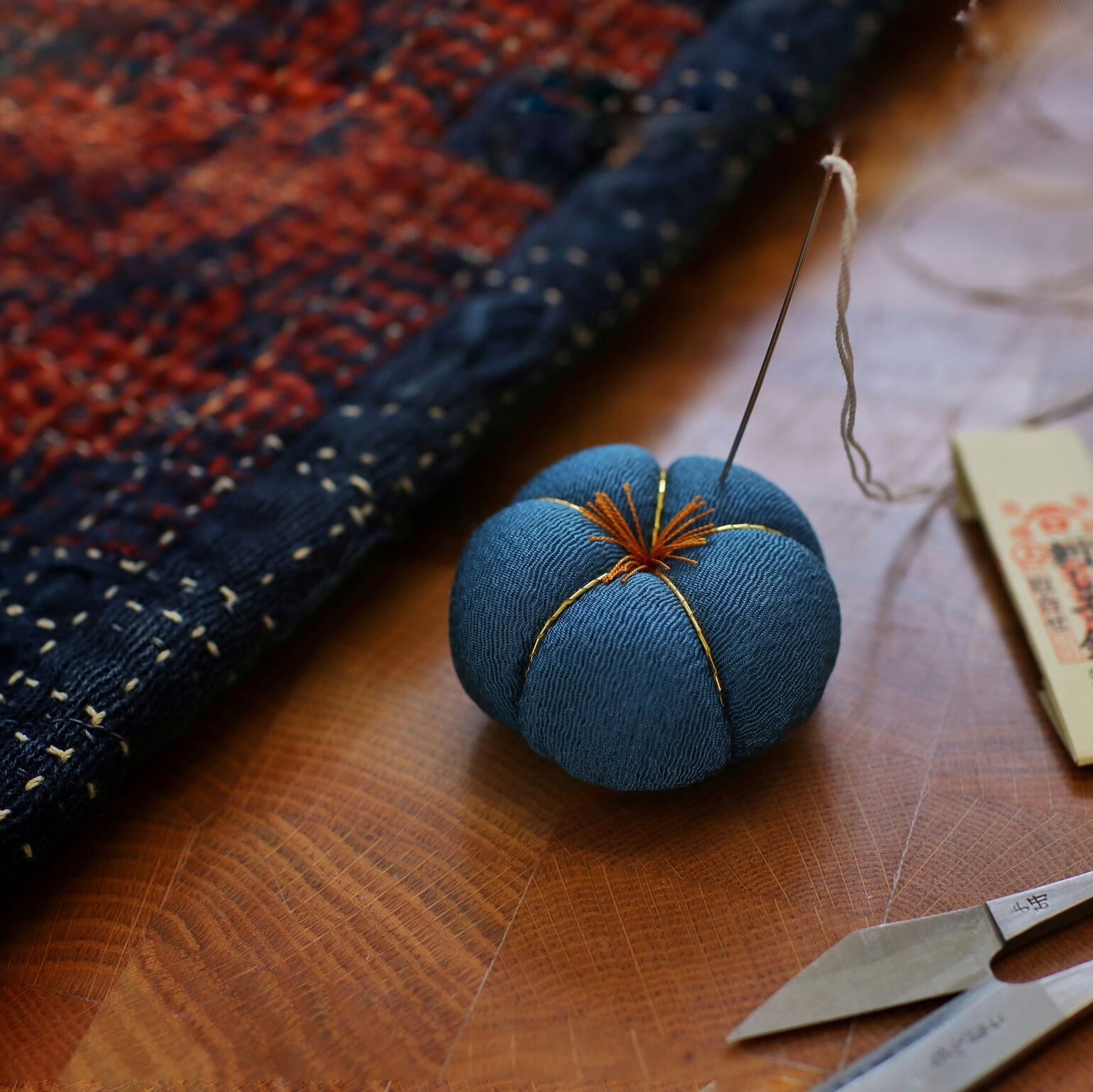 needle and thread in pin cushion