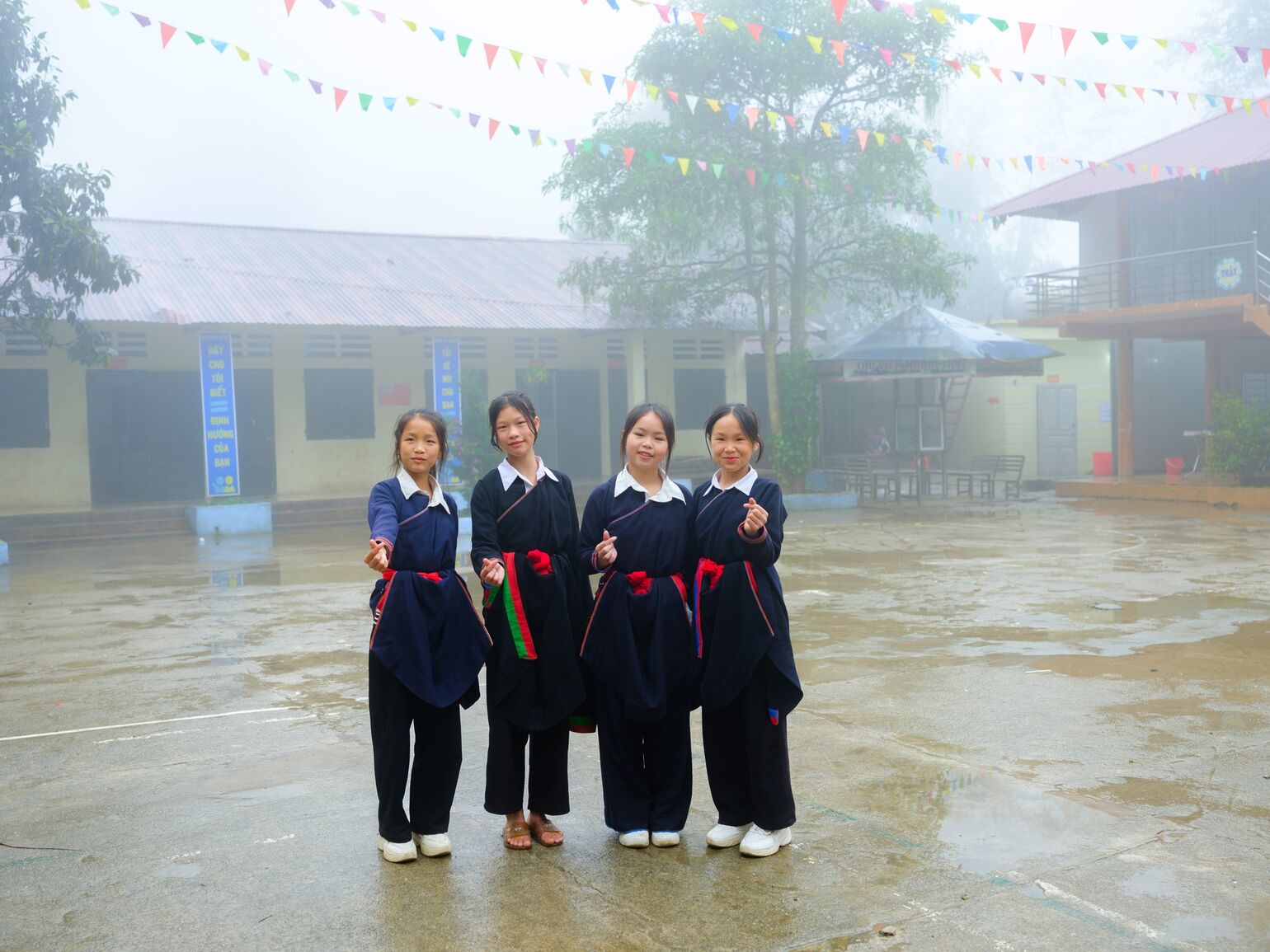 A group of female students makes the heart sign