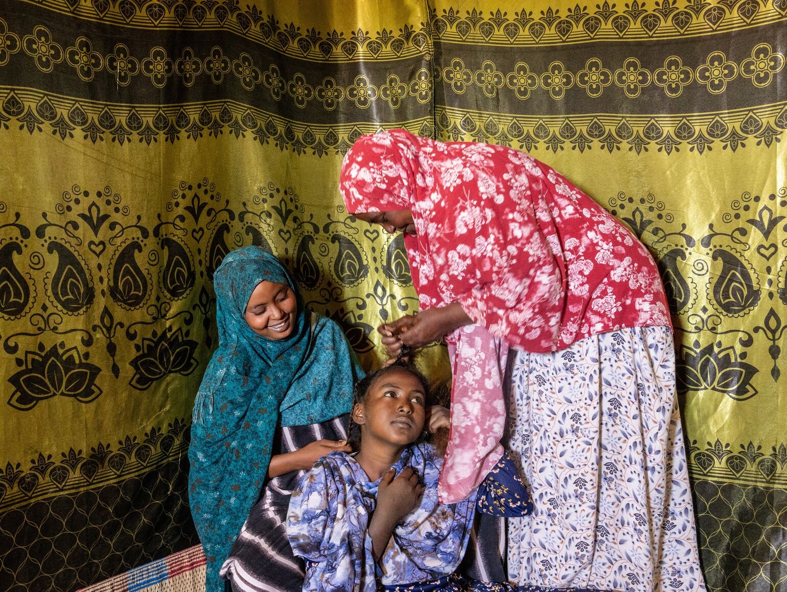 Ikran Abdulahi Ali at home with her daughters