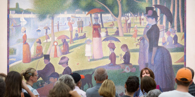 Museum visitors looking at a Georges Seurat's A Sunday on La Grande Jatte artwork