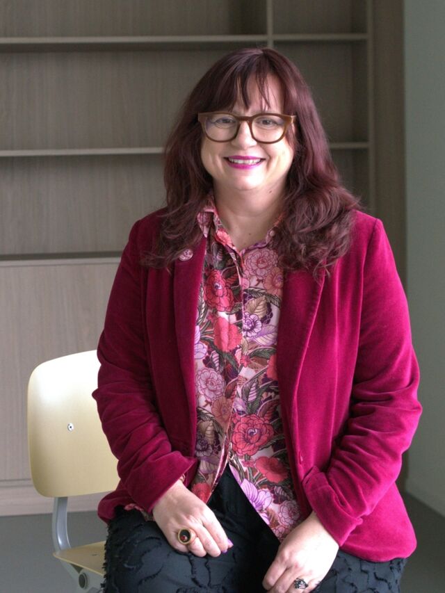 Clare Stewart seated for interview