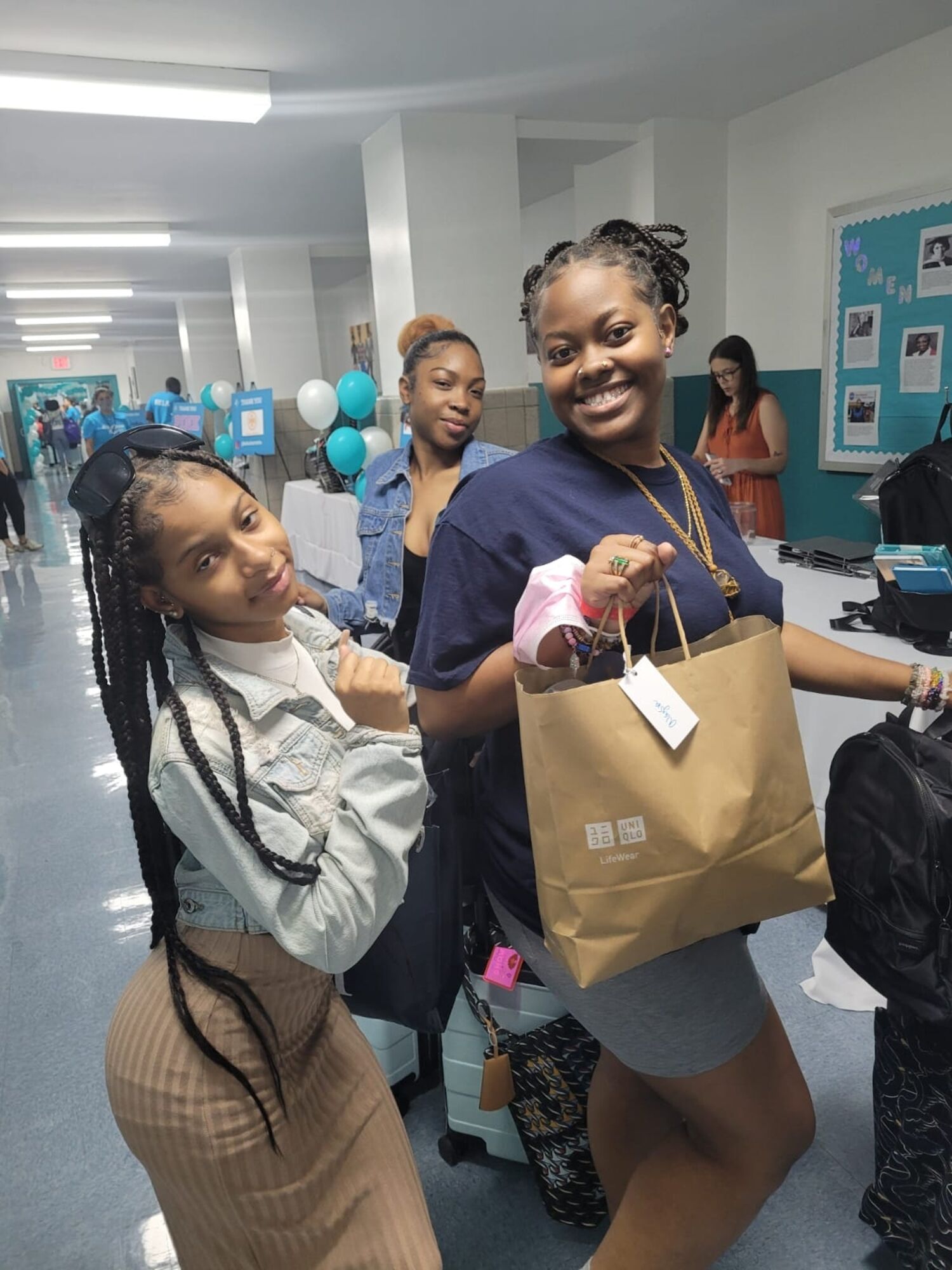 girls holding jackets