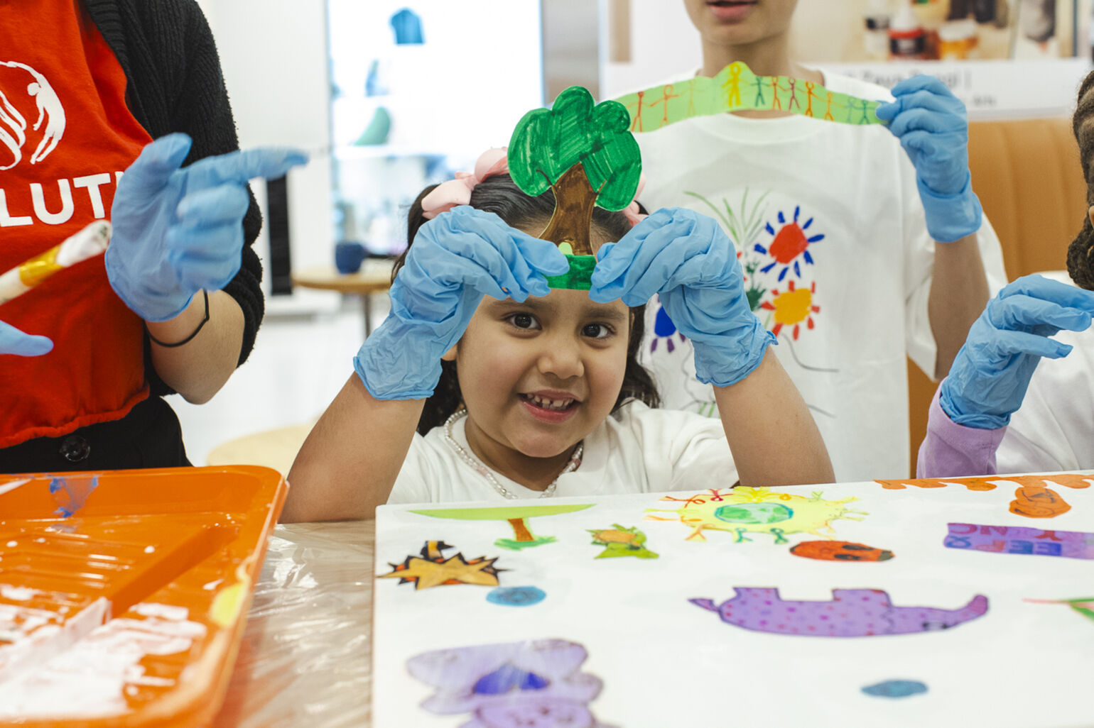 Young girl holding up a piece of art
