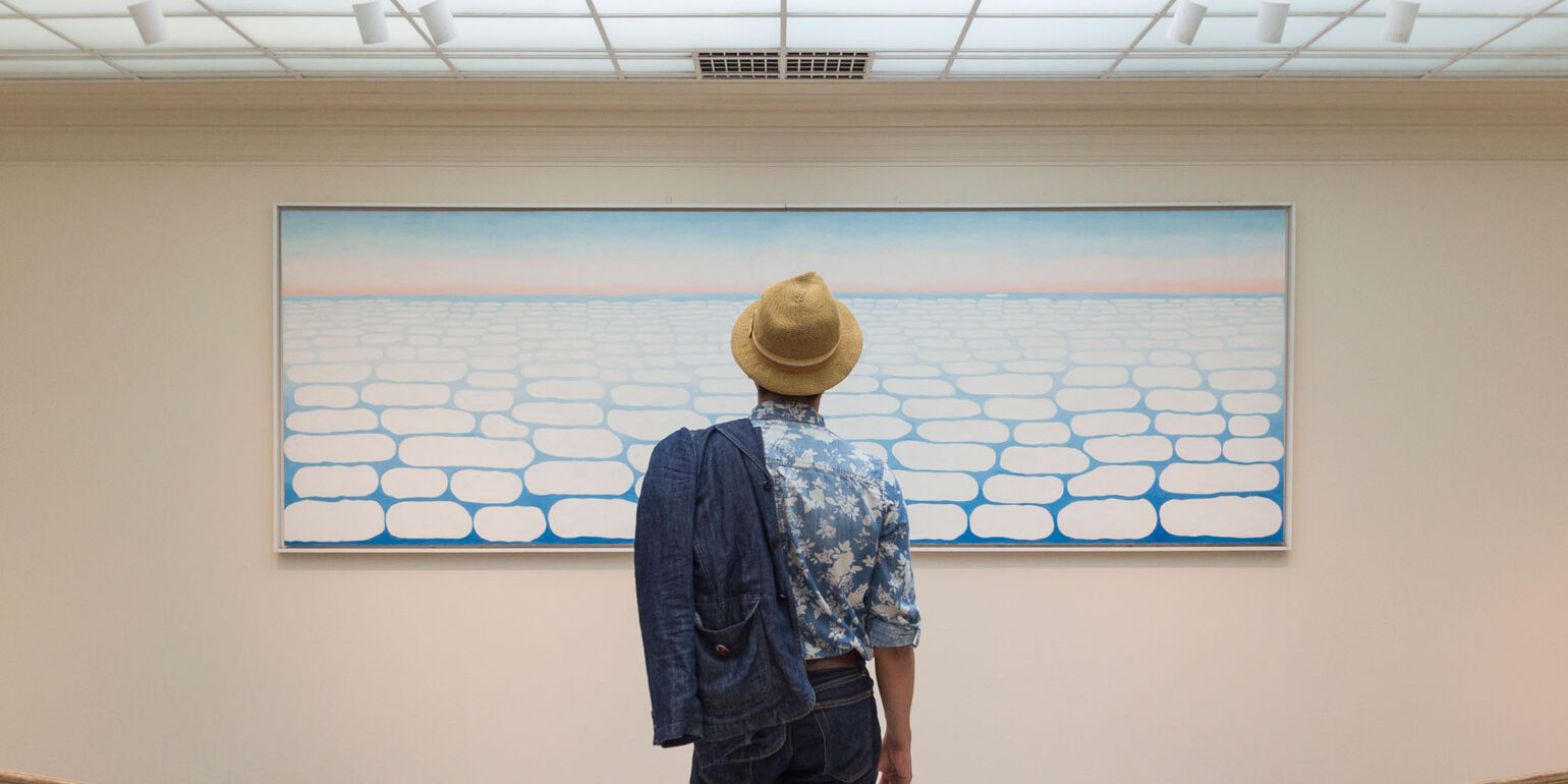 Visitor standing in front of the Sky above Clouds IV by Georgia O’Keeffe