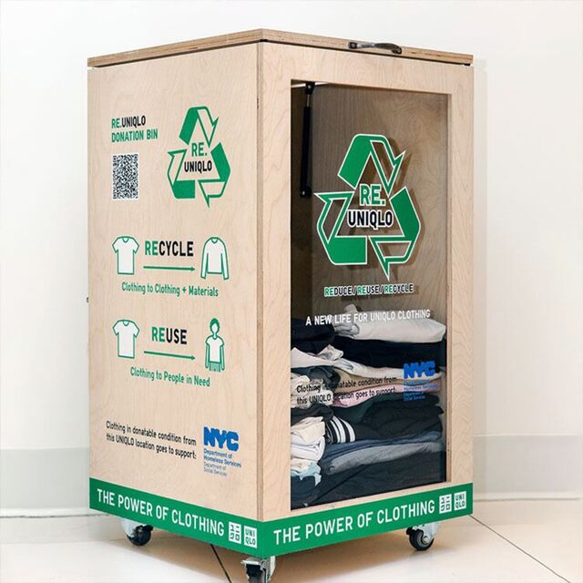 Wooden UNIQLO RE.UNIQLO clothing donation bin highlighting clothing recycling program and clothing donation initiative, with recycle and reuse graphics and garments inside